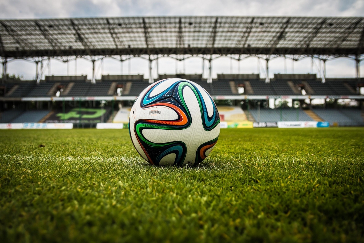 multicolored-soccer-ball-on-green-field-47730-scaled.jpg